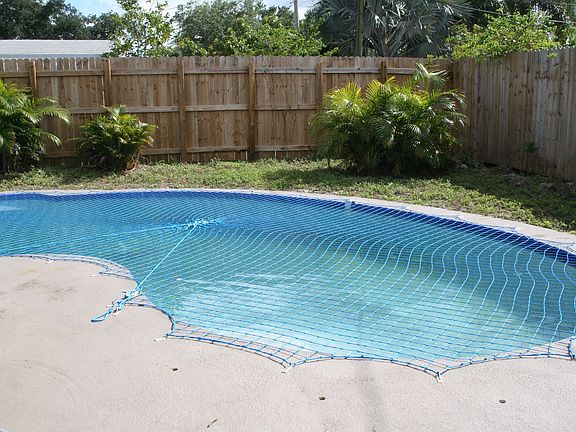 In ground pool with safety net