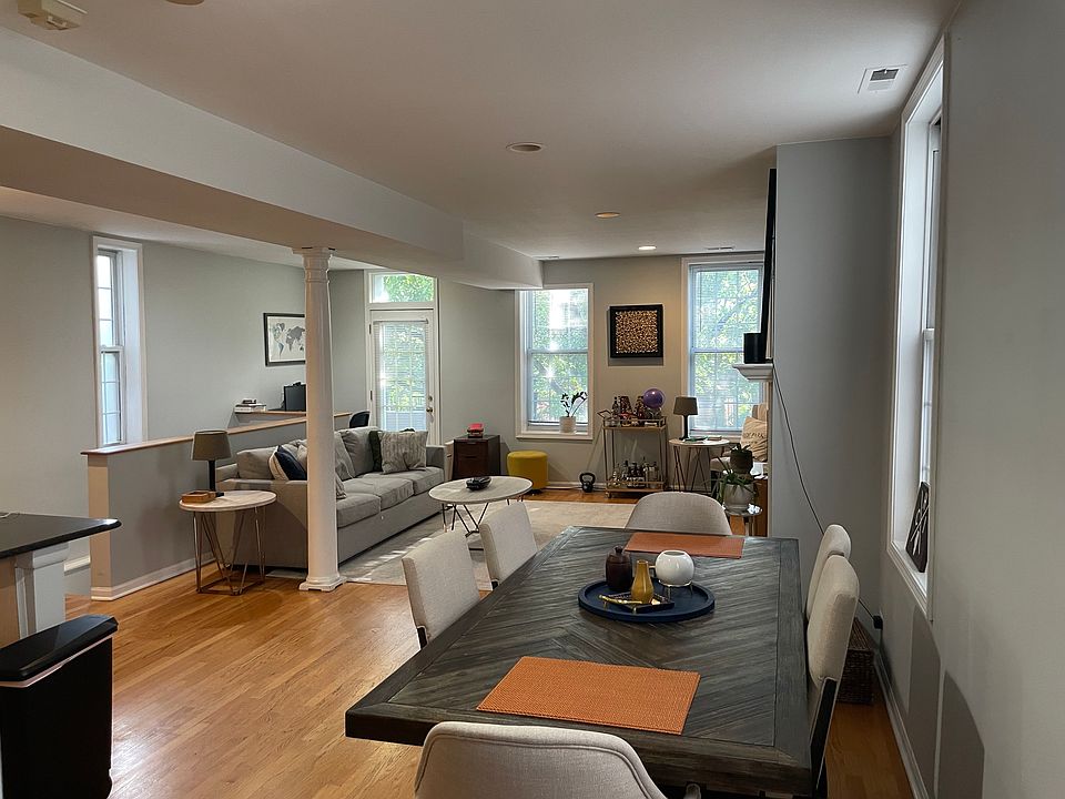 Open dining area next to the kitchen with hardwood floors, space for a full-size dining table, and an easy flow into the main living area.