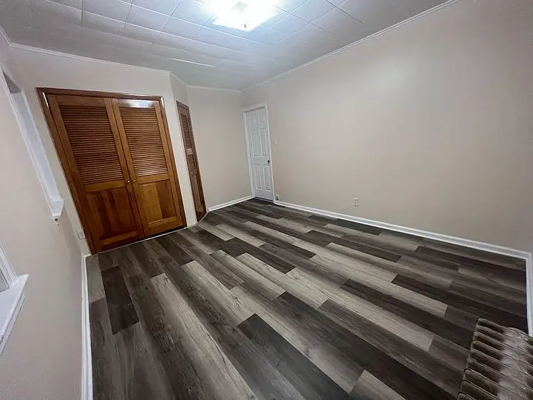 (Master Bedroom 2/3) The main built in closet offers a rod for hanging clothes.