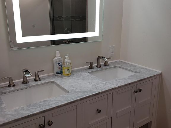 Our fully remodeled bathroom features a easy walk in shower, a brand new 2 sink vanity cabinet with a marble counter top. Dimmable lights make for a cozy atmosphere while taking a shower and as a very special highlight a light up mirror.