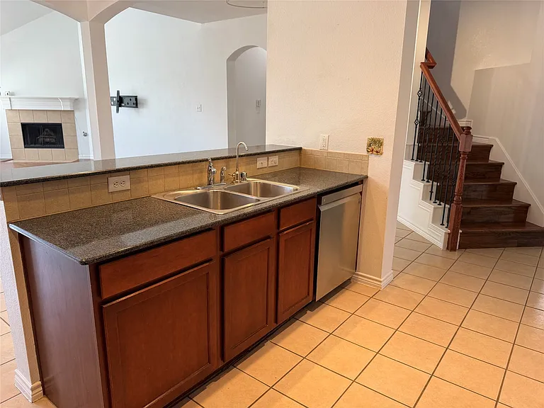 View from kitchen to living room with cozy fireplace.