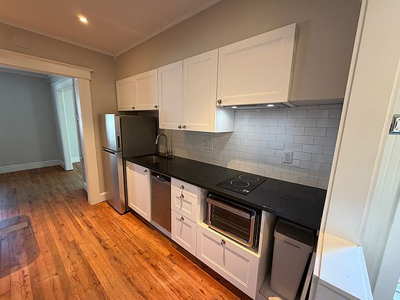 Freshly renovated kitchen with induction cooktop and 9 in 1 oven, lots of storage. Dishwasher, garbage disposal and fridge with ice maker.