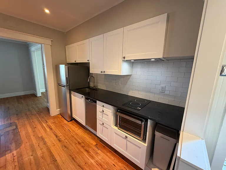 Freshly renovated kitchen with induction cooktop and 9 in 1 oven, lots of storage. Dishwasher, garbage disposal and fridge with ice maker.