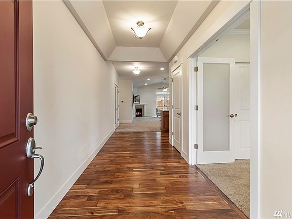 Extra wide hall as you walk into the home with gleaming floors.