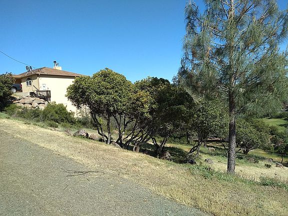 Paved road, nice house next door