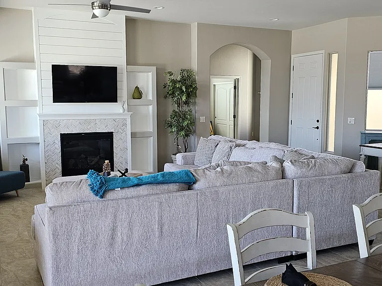 living room with Wide Screen entertainment center with streaming Dish TV. Gas Fireplace.