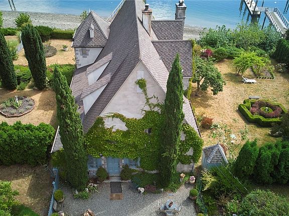 Wecome Home! Surrounded By Landscaped English Garden "Rooms" With Fruit Trees And An Extra Lot To Right, This Waterfront Home Awaits You. With Deep Moorage Dock; An Artist Studio 336' Building and Over 600' Detached Garage There Is Ample Storage For All Your Toys