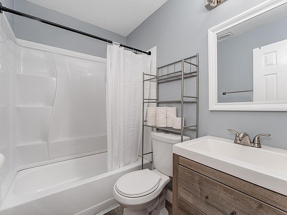 This bathroom is complete with a bathtub and standing shower.