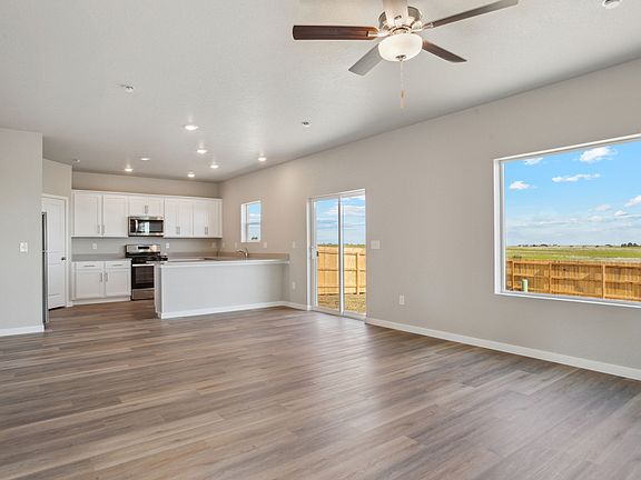The family room is spacious with a ceiling fan.