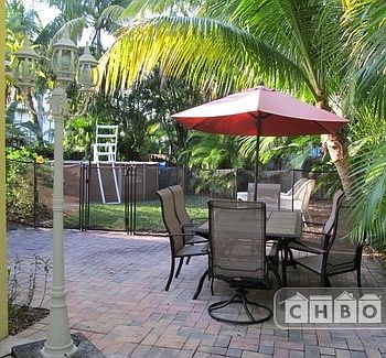 Fenced in yard with above ground pool, gas grill and patio t