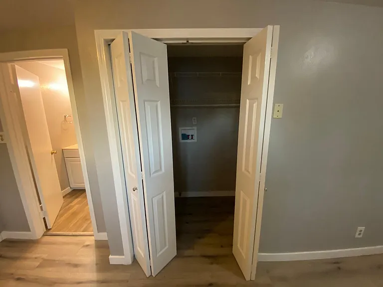 Laundry Closet featuring shelving racks for storage and hanging.
