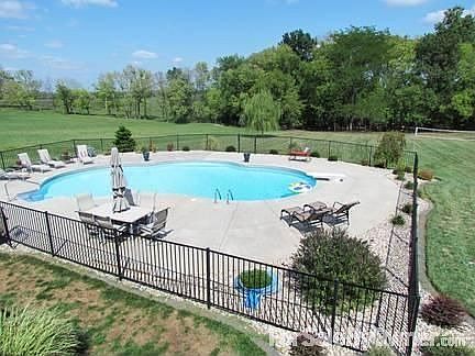 View of Pool from Upper Deck
						:
						Large level yard backing to woods. We also have a volleyball net up.