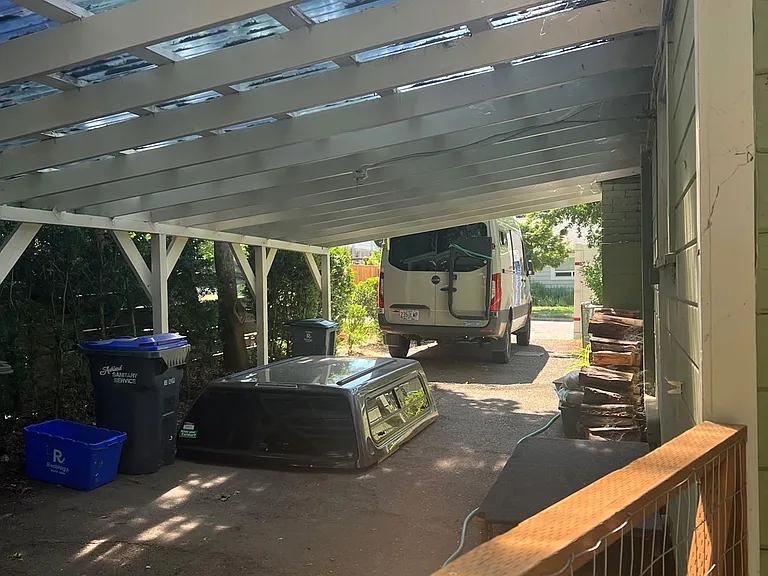car port and gate to fenced, large back yard