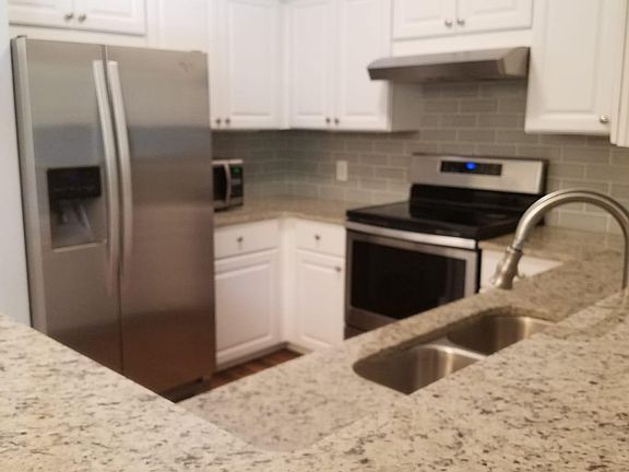 Breakfast bar is granite countertops with new cabinets and stainless steel appliances!