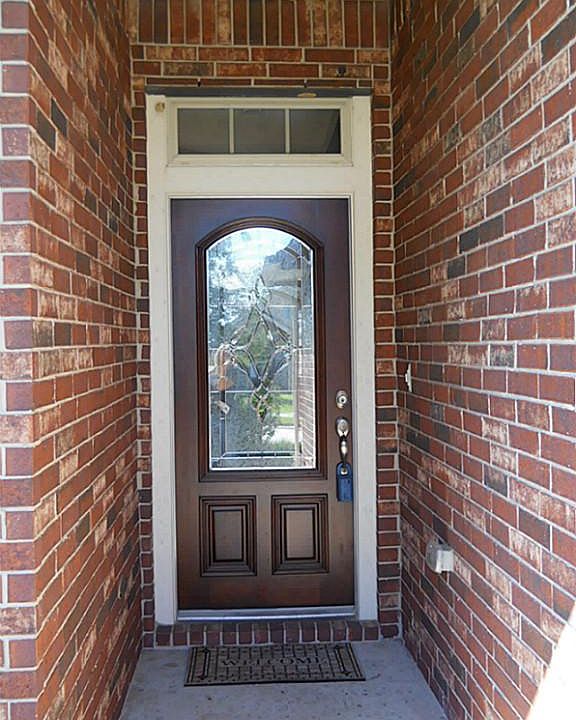 Nice Covered porch for your guests with pretty leaded glass front door