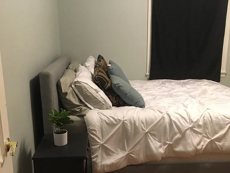west bedroom (room for rent). full size closet. room has two modern, updated windows. furnished with bed, white desk, lamp, off white chest of drawers and shelving