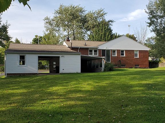 Backyard view. Garage door to the yard and an extra covered storage area.