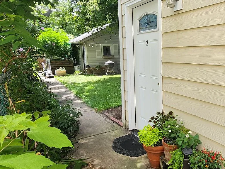 Private back/side door, within fenced-in backyard, with gated entrance.