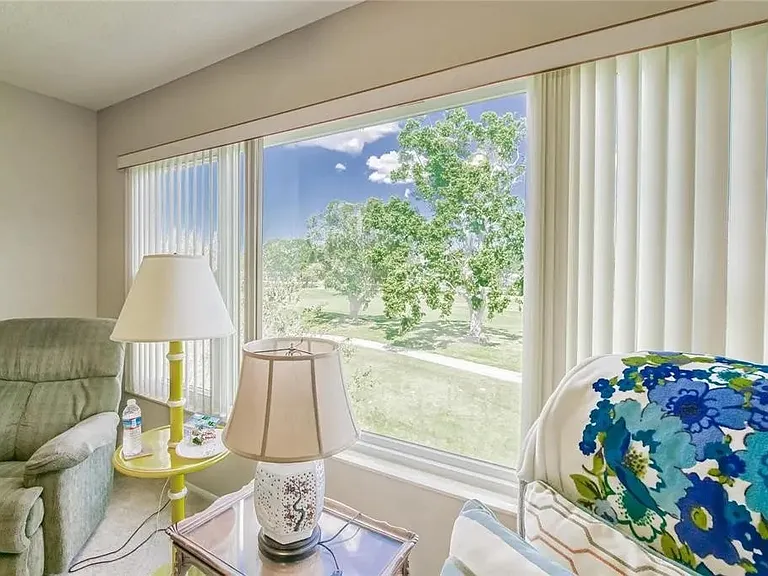 Florida room with picture window overlooking golf course.

 *This unit is unfurnished. All furniture has been removed.
