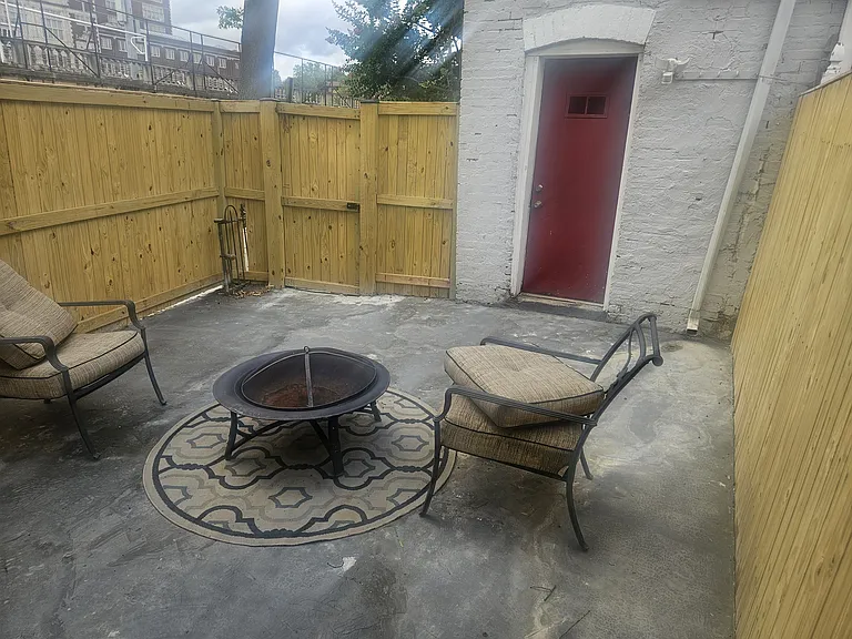 Attached spacious and private side patio measuring 13' x 17'. Perfect for grilling, outdoor dining, and entertaining. Extra, secure storage / utility closet (red door).