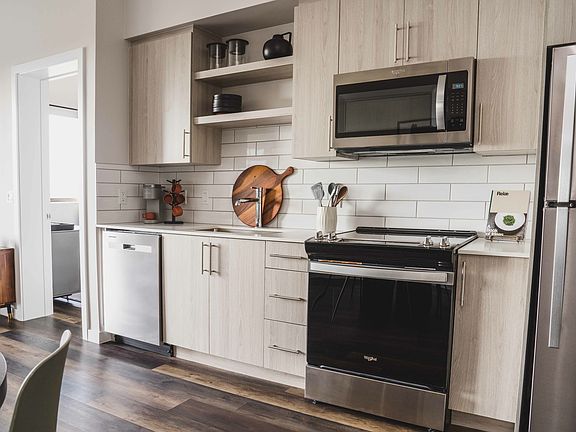 The kitchen features sleek stainless steel appliances.