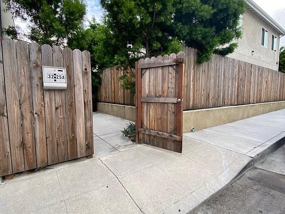 PRIVACY FENCE AND GATE ENTRANCE TO UNIT