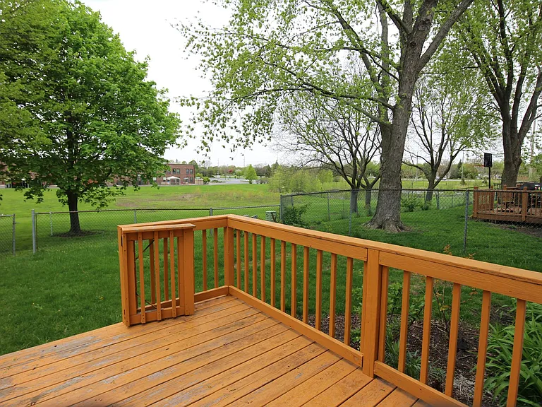 Fenced deck in small fenced yard.