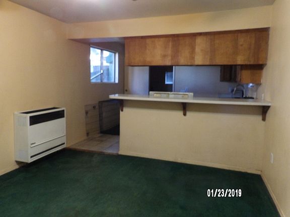 FAMILY ROOM, BREAKFAST BAR, AND KITCHEN.