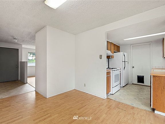  Dining room, looking into the kitchen on the right and entry way to the left.