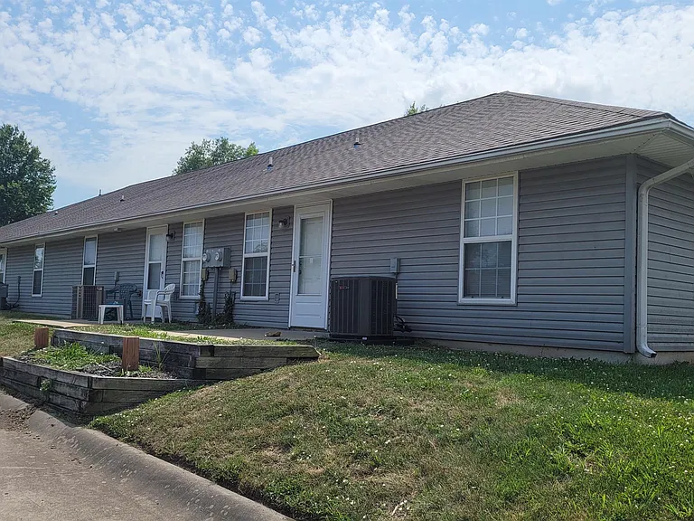 Back of unit with concrete patio.
