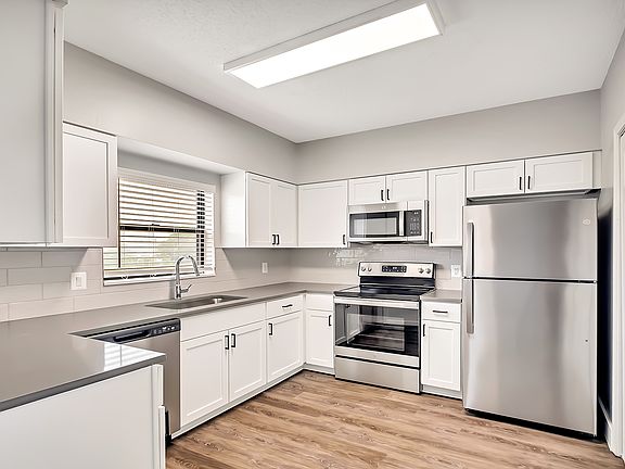Select homes have upgraded kitchens with quartz countertops and wood flooring