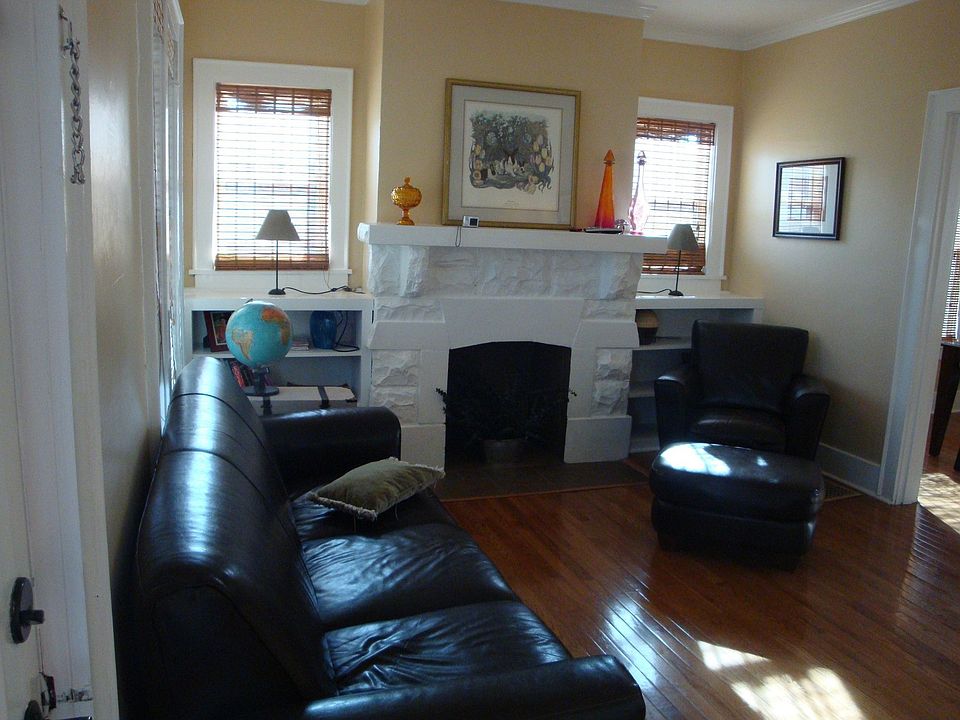 Living Room has hardwood floor, fireplace & built-in book cases