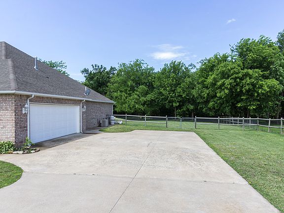 A partial view of the back yard and wooded area in back
