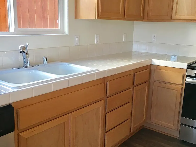 Kitchen has plenty of cabinet space, white double sink.