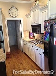 Kitchen
						:
						Doorway leads to garage, laundry room and half bath.