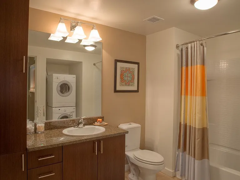 Classic Package I bath with brown speckled granite countertops, espresso cabinetry, and hard surface flooring