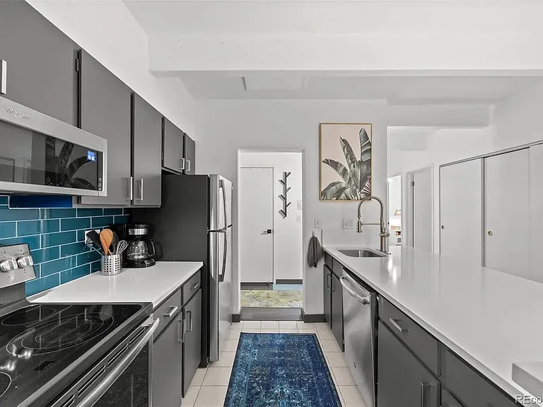 View of pantry door through the opening where many cooking supplies are stored