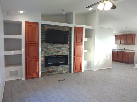 Real rock backdrop with inset electric fireplace and TV mounts. (TV not included)