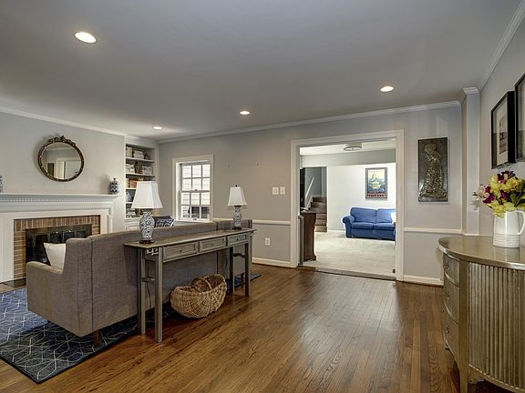 Living room connects to a carpeted den off the back of the house.