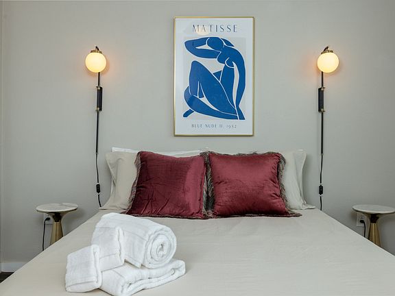 Bright and airy primary bedroom with a cozy queen bed, flooded with natural light_your perfect retreat for rest and relaxation. This bedroom is located on the first floor.