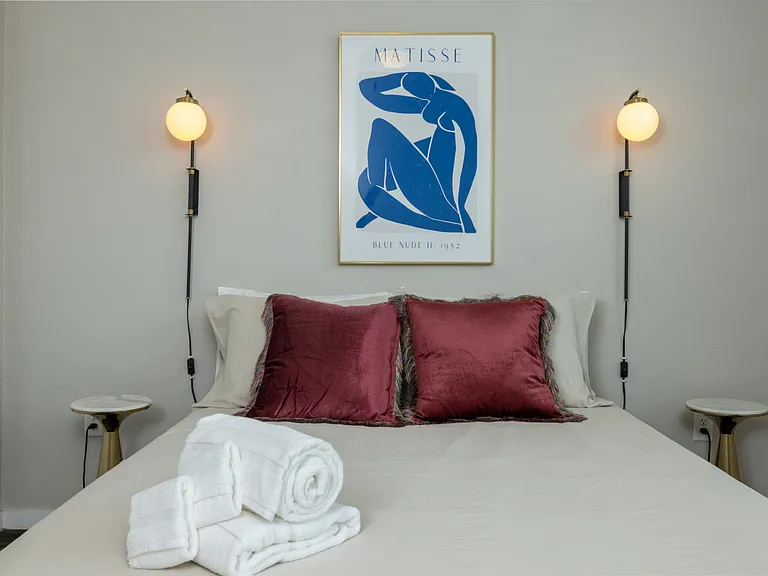 Bright and airy primary bedroom with a cozy queen bed, flooded with natural light_your perfect retreat for rest and relaxation. This bedroom is located on the first floor.
