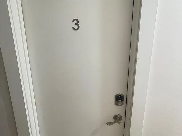 Private entry door with keypad lock offers convenient, secure access to the home.