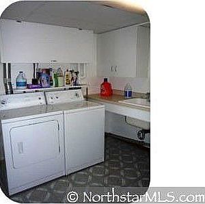 Get all of your laundry done in this spacious room with cupboards and a sink!