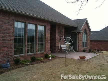 Back patio and yard. : Manicured lawn and landscaped.
