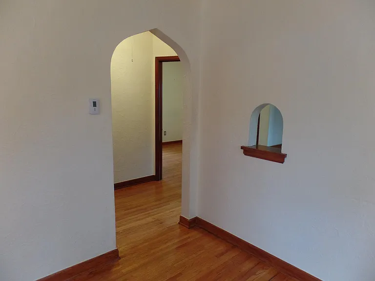 To the Foyer. Foyer has 2 bedrooms, bathroom, stairs to bedroom upstairs and the kitchen branching off of it.