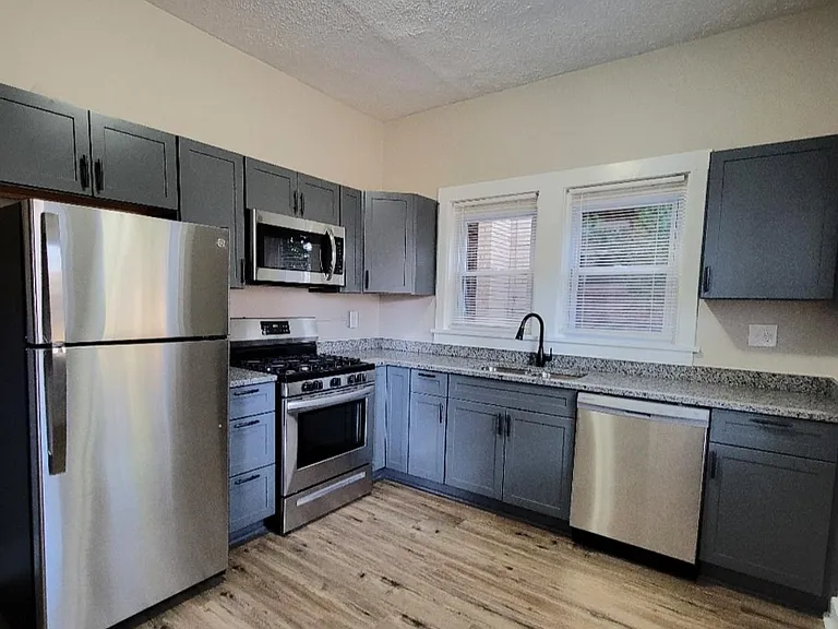 Updated kitchen featuring high profile cabinets, granite counter tops & stainless steel appliances.