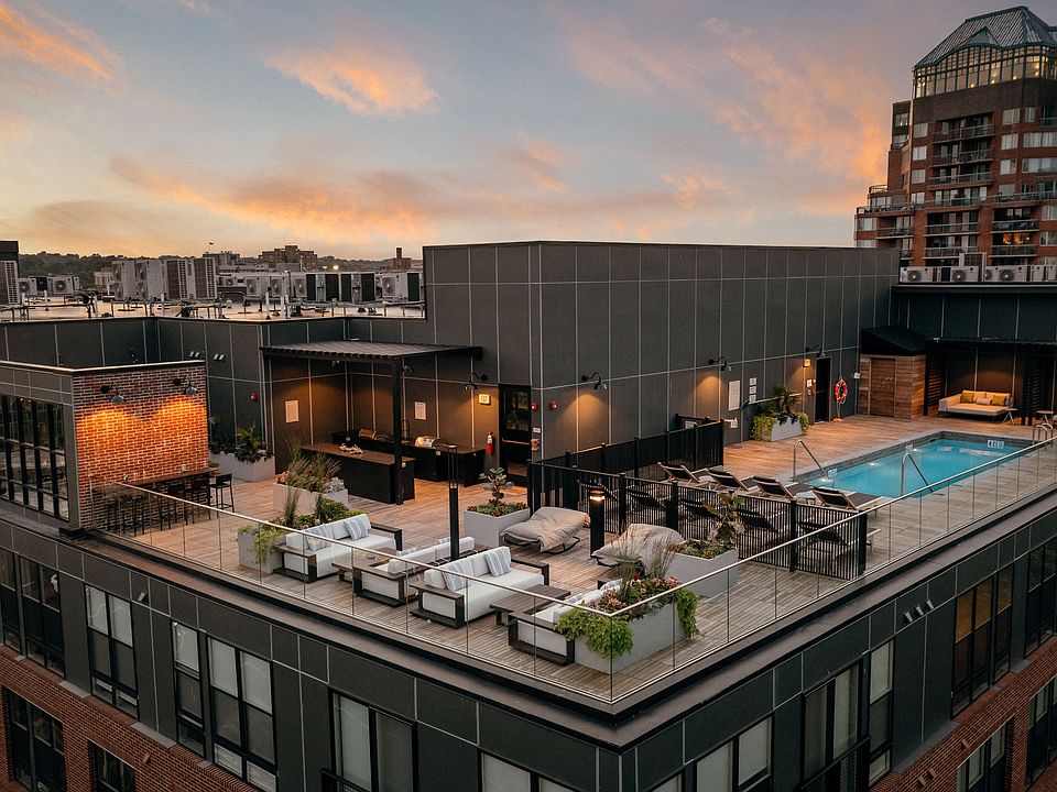 Rooftop lounge area featuring poolside seating and cabanas