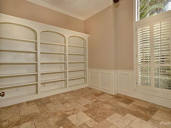 The study has beautiful built-in shelves.