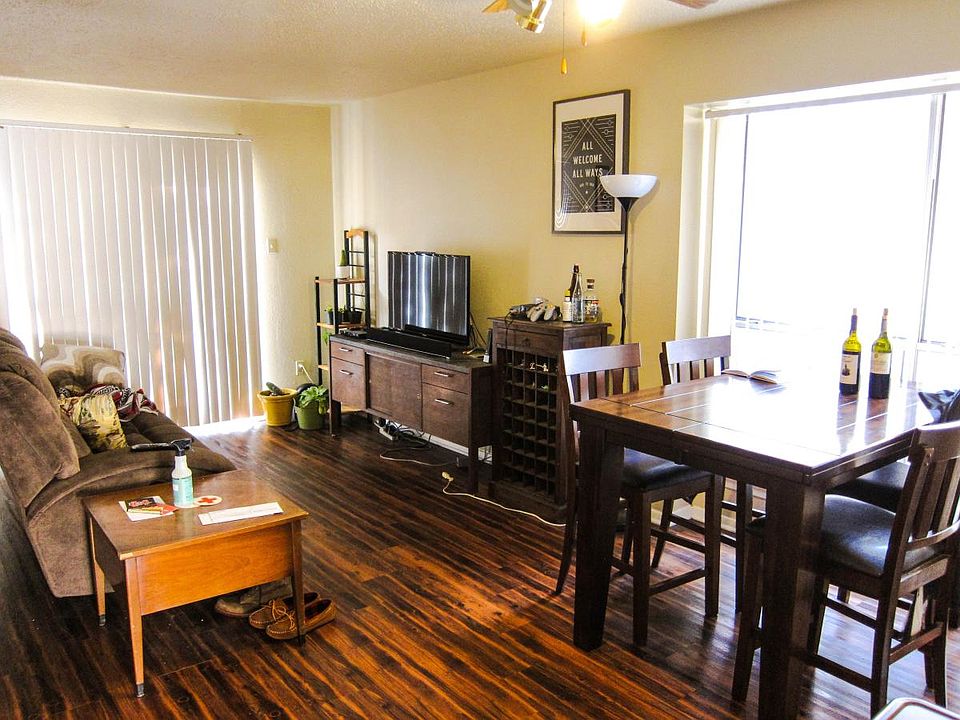 Living room and dining area. Staged with previous tenant's furniture.