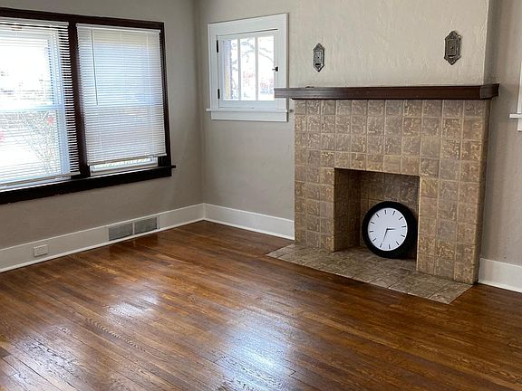 Master bedroom features built in cabinets with a decorative fireplace. Walk in closet.